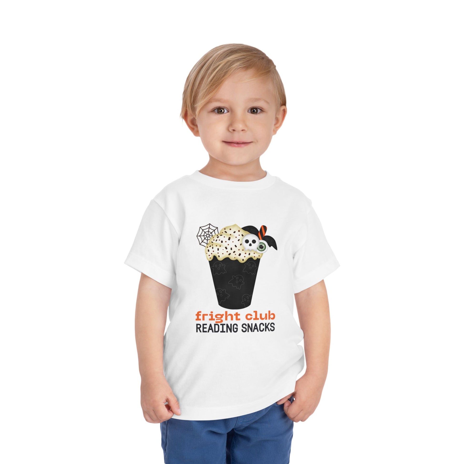 Child wearing a white t-shirt with Halloween-themed  foamy beverage design and text "fright club reading snacks' on a white background