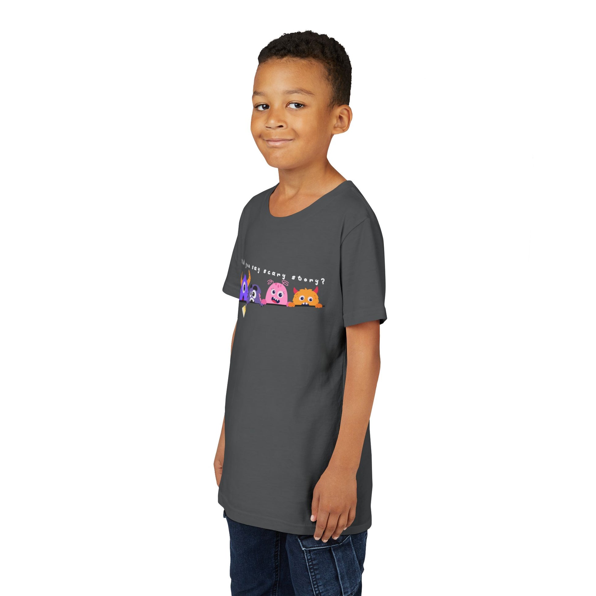 Boy wearing a gray t-shirt with a row of worried colorful cartoon monsters peaking over the edge of a line and text 'Did You Say Scary Story?' 