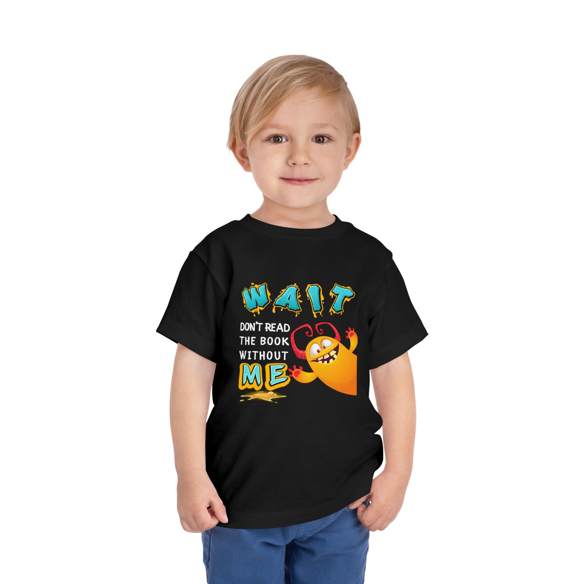 Child wearing a black toddler t-shirt with a monster jumping into frame from the side and text 'WAIT Don't REad The Book Without ME'