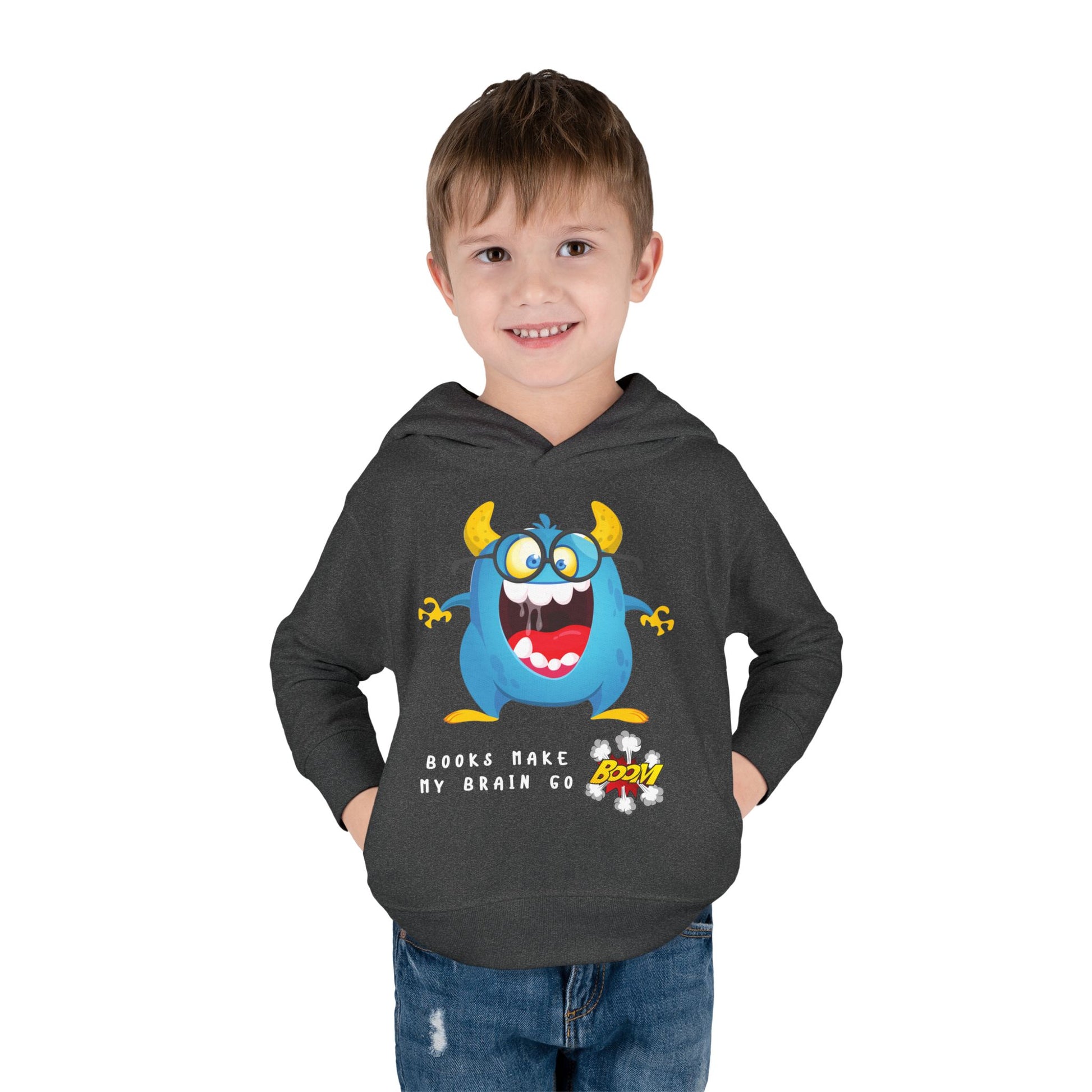 Boy wearing a dark gray hoodie with a blue and yellow cartoon monster, text 'books make my brain go boom'