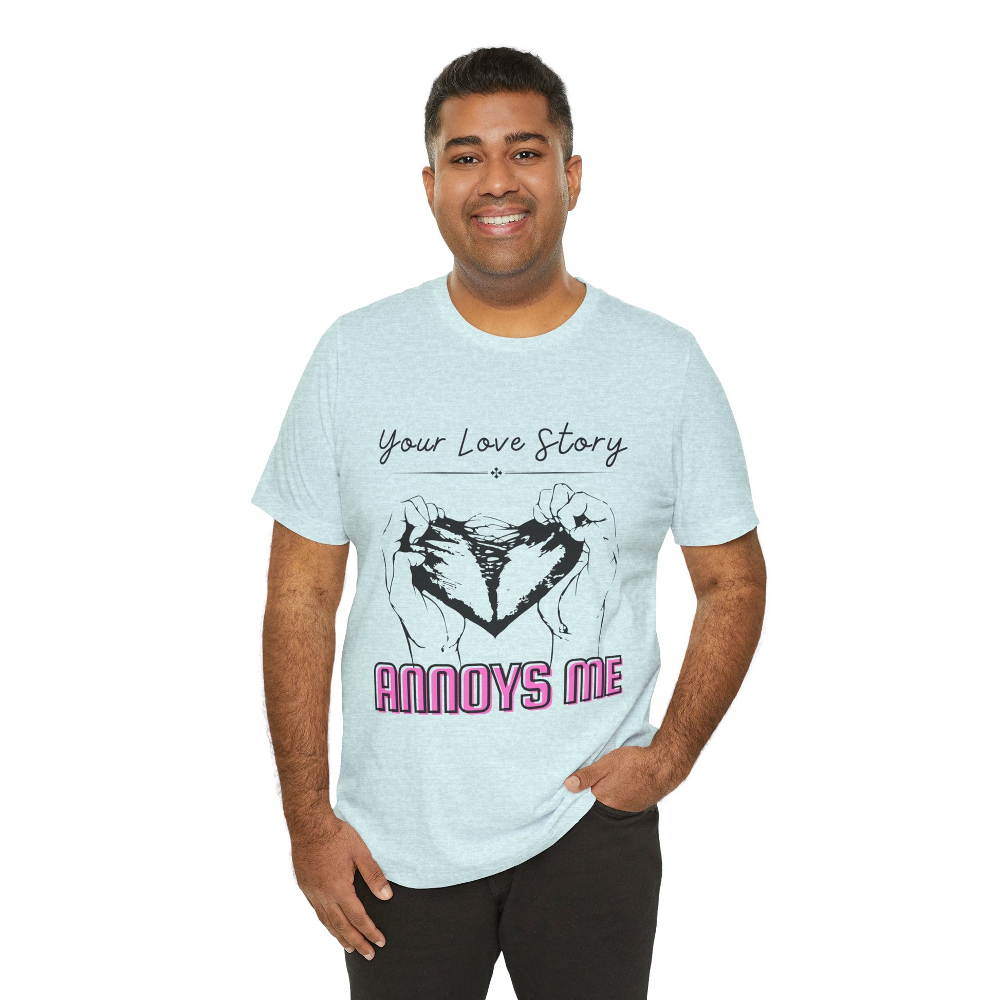 Man wearing an icy blue t-shirt with graphic design of two hands pulling apart a heart and text 'Your Love Story ANNOYS ME'