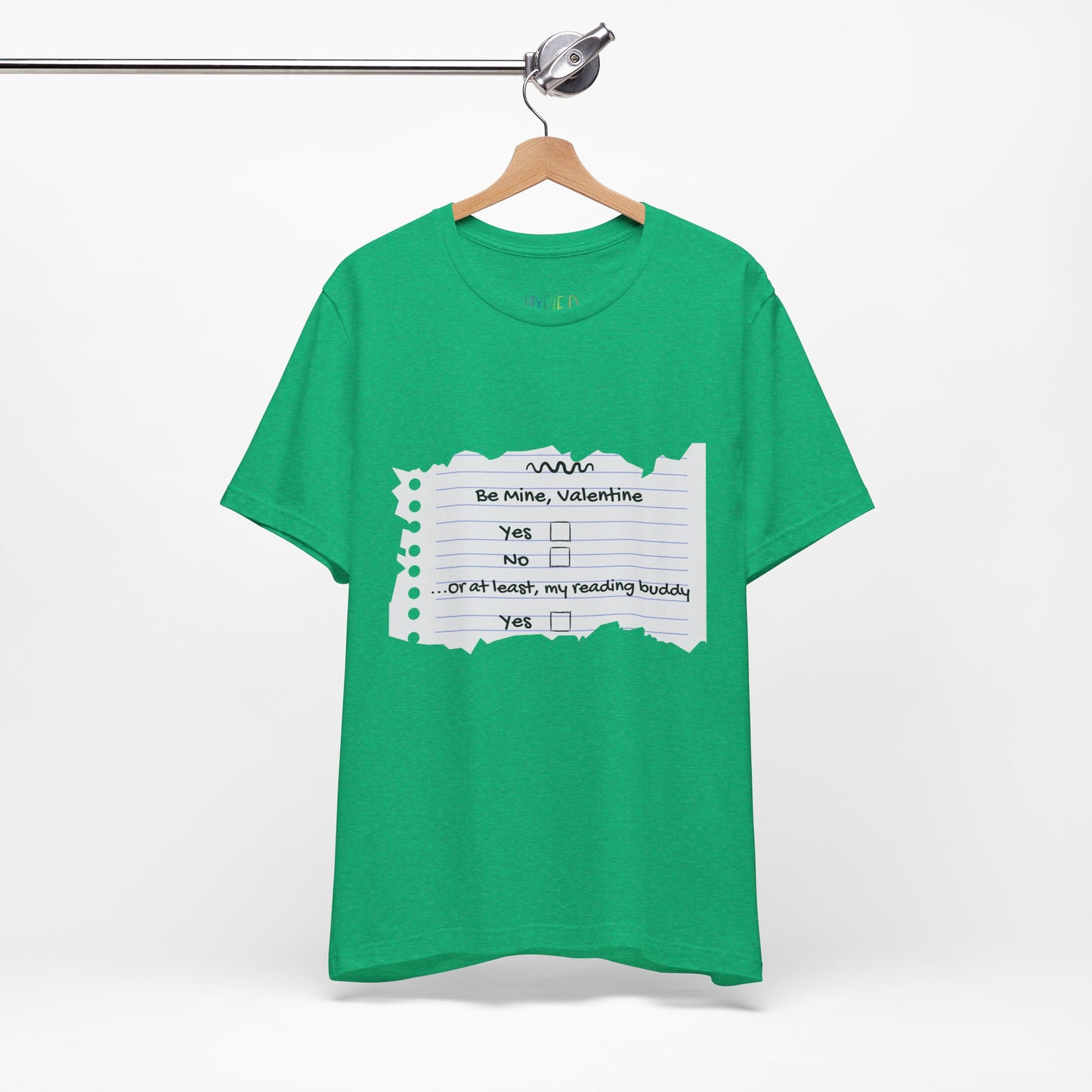 Green t-shirt with an image of torn notebook paper and old school checkboxes depicting 'Be Mine Valentine, Yes, No' and 'Or At Least , My Reading Buddy, Yes'