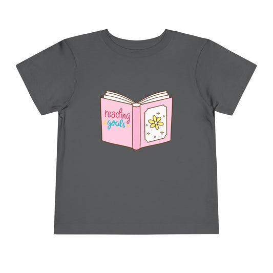 Gray toddler t-shirt with a pink book graphic and 'reading goals' text 