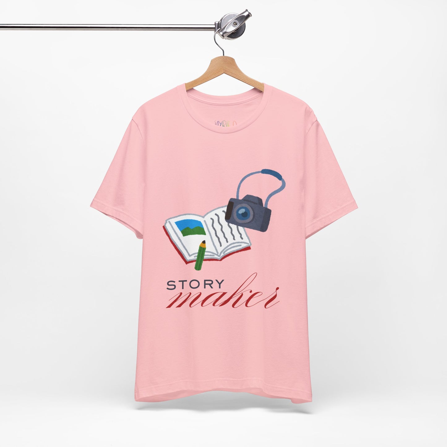 Pink t-shirt with an open book, pencil and camera, 'Story Maker' text beneath
