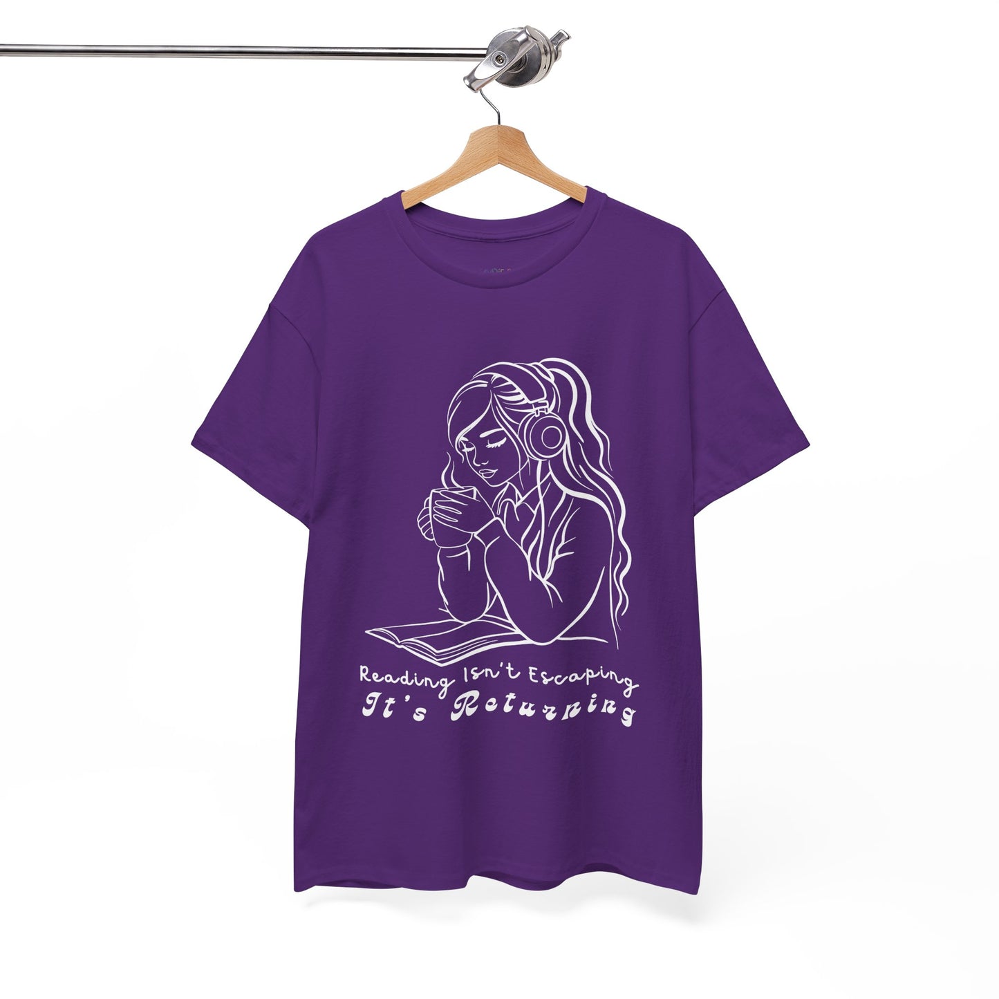 Purple t-shirt with a woman wearing headphones, cupping a hot beverage and reading a book, text 'Reading Isn't Escaping, It's Returning'