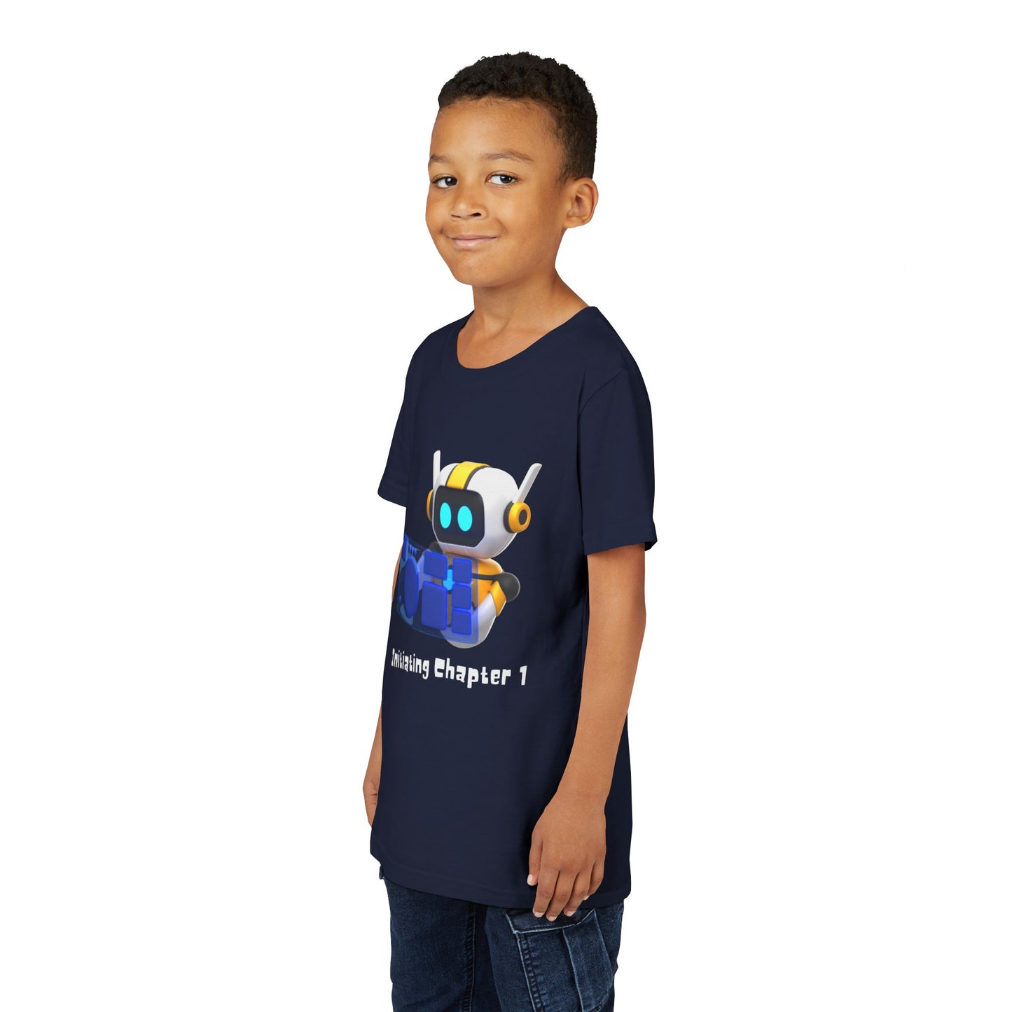 Boy wearing a navy blue t-shirt with a robot graphic, computer and text 'initiating chapter 1'