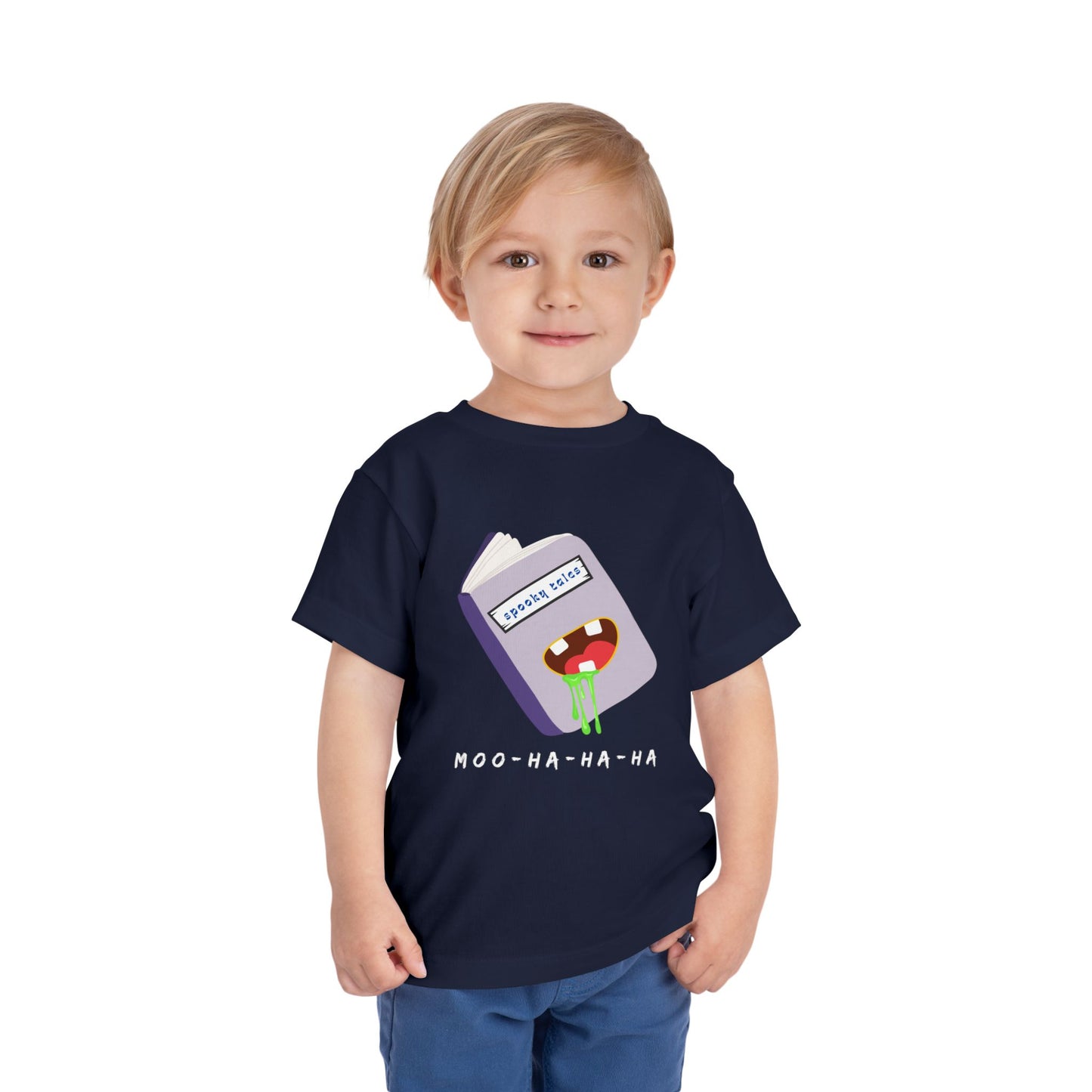 Child wearing a navy blue toddler 'Moo-Ha-Ha-Ha' spooky tales t-shirt on a white back ground