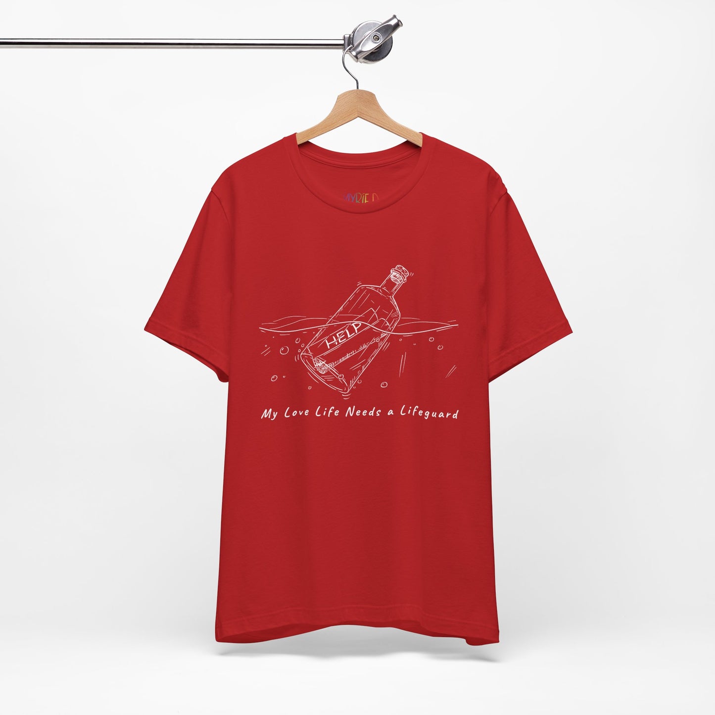 Red t-shirt with white sketched image of a bottle floating in water with a rolled up paper inside that says 'help' and text below 'My Love Life Needs a Lifeguard'