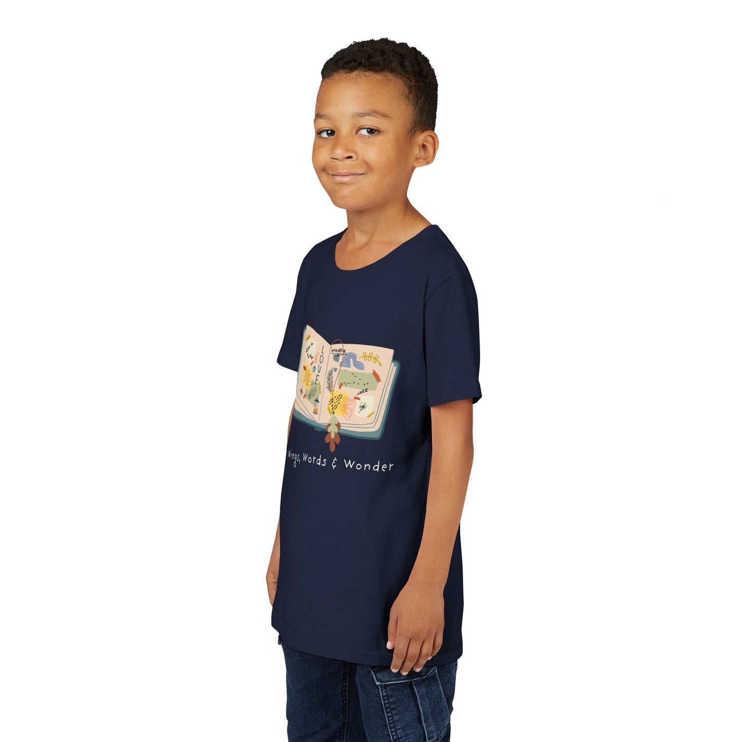 Boy wearing a navy blue t-shirt with an open scrap book  and text 'Wings, Words & Wonder' 