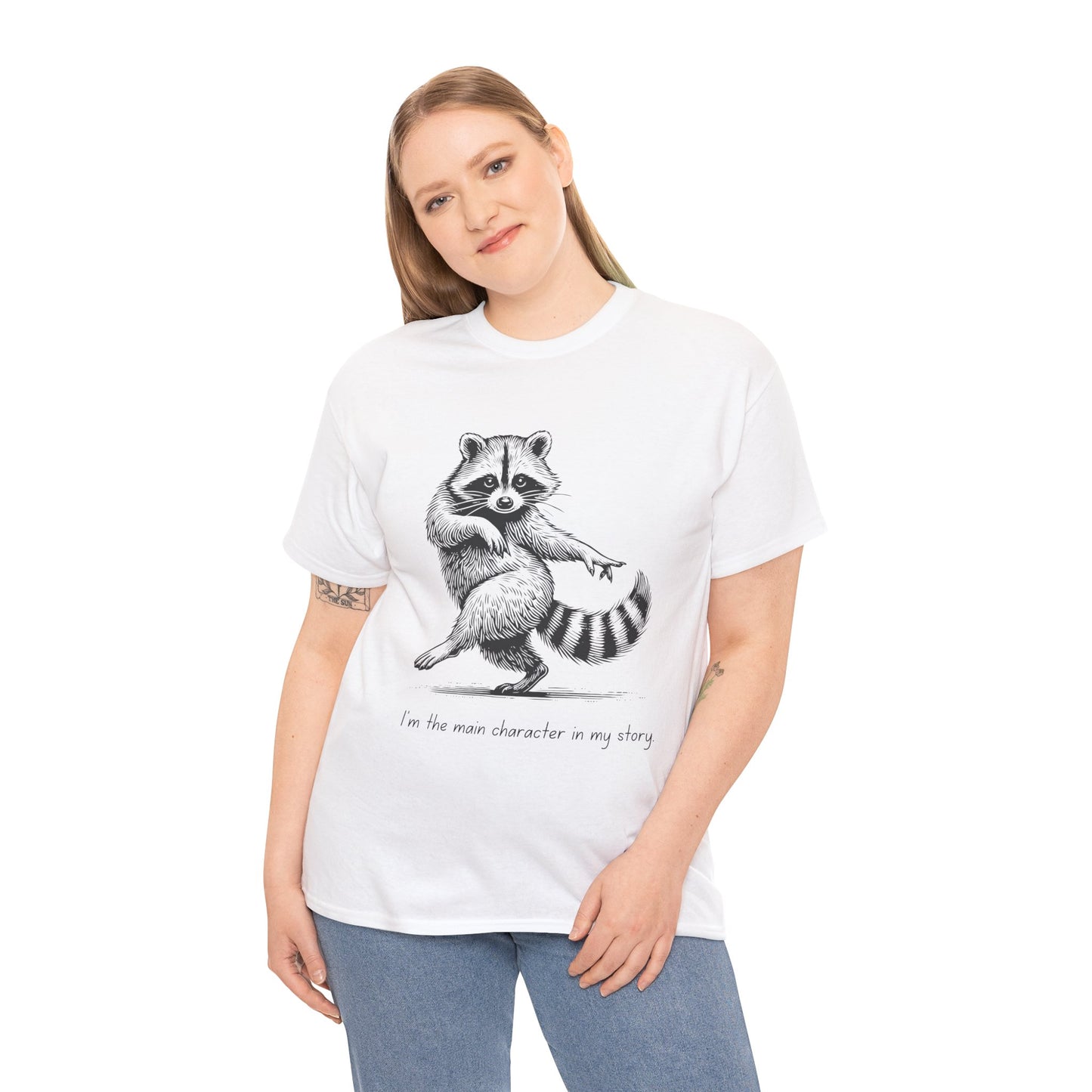 Woman wearing a white t-shirt with a dancing raccoon graphic and text 'I'm the main character in my story'