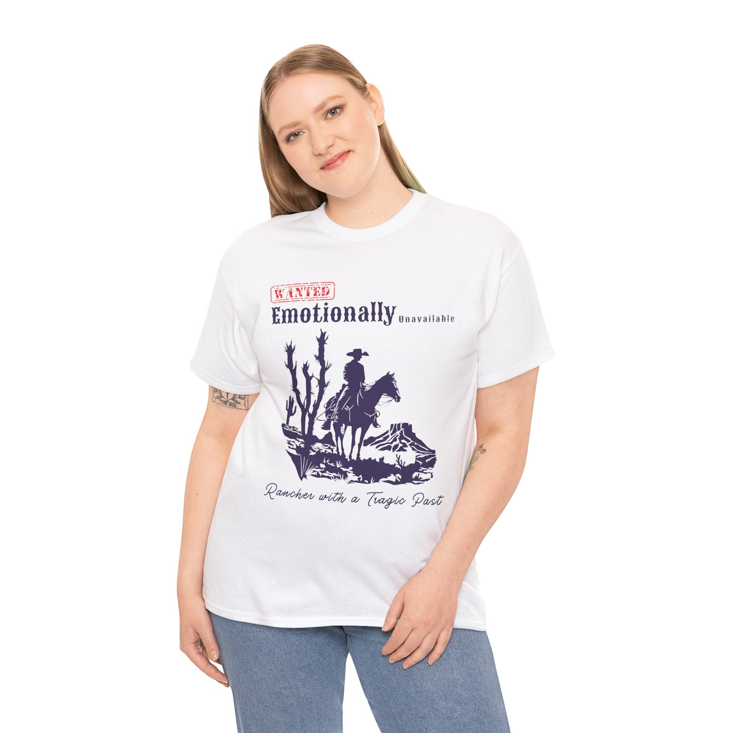 Woman wearing a white t-shirt with a horse riding cowboy in a desert setting and text 'WANTED Emotionally Unavailable Rancher With A Tragic Past'