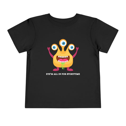 Black toddler t-shirt with a drooling, three-eyed monster graphic and text 'Eye'm all in for storytime' on a white background