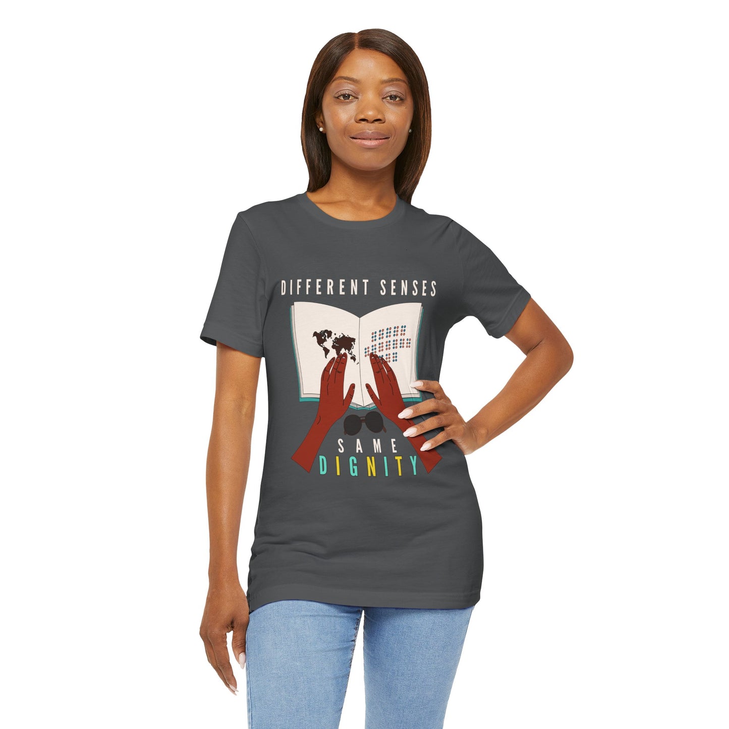 Woman wearing a gray t-shirt with graphic of two hands touching a braille book and text 'Different Senses, Same Dignity'