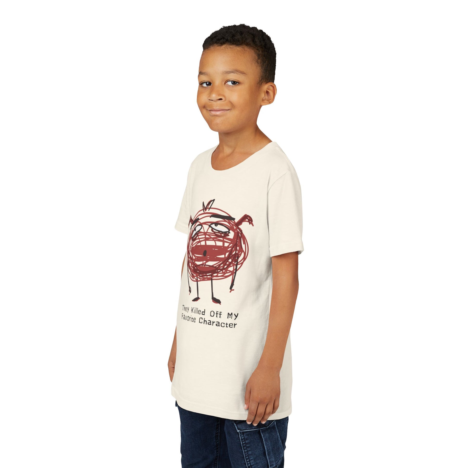 Boy wearing a beige t-shirt with a red scribbled character and text 'they killed off my favorite character'