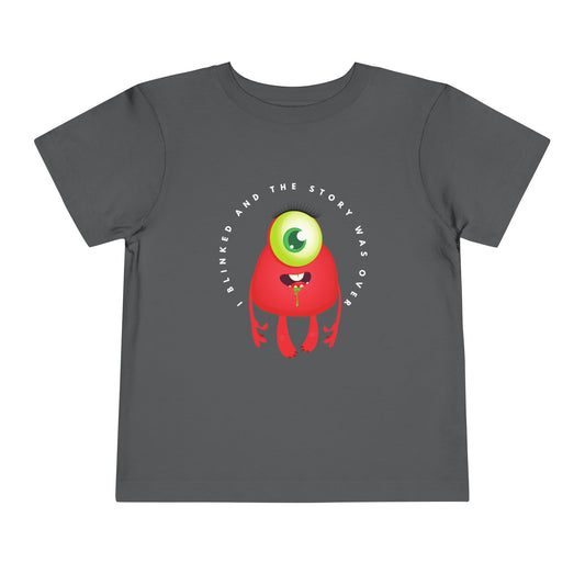Gray toddler t-shirt with a drooling, one eyed, red monster graphic and text 'I blinked and the story was over'