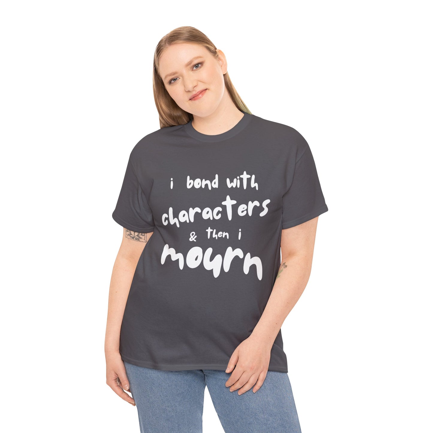 Woman wearing a gray t-shirt with exaggerated sized letters and text 'I Bond With Characters & Then I Mourn'