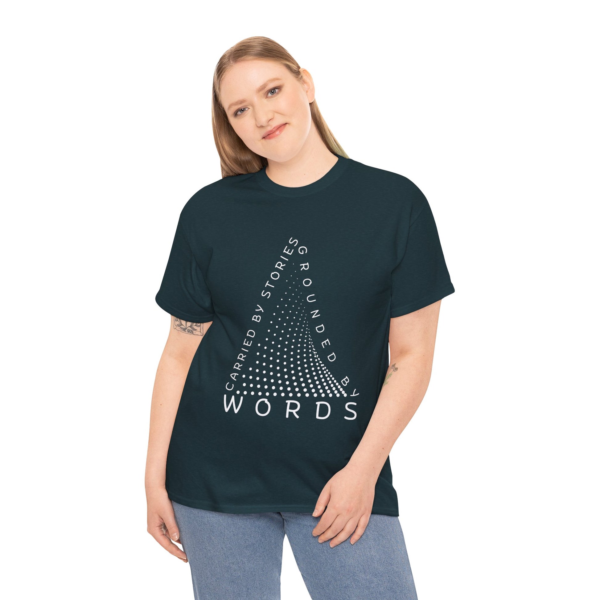 Woman wearing a midnight t-shirt with white text that follow the outline of a dotted triangle 'Carried By Stories, Grounded By Words' 