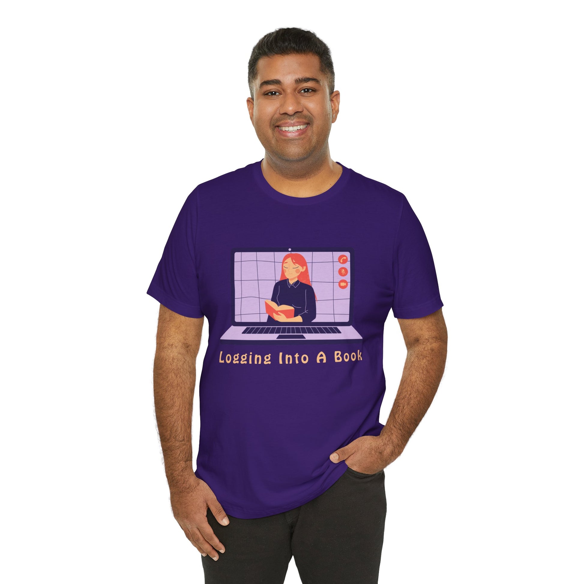 Man wearing a purple t-shirt with open laptop featuring a woman reading a book and text 'Logging Into A Book' 