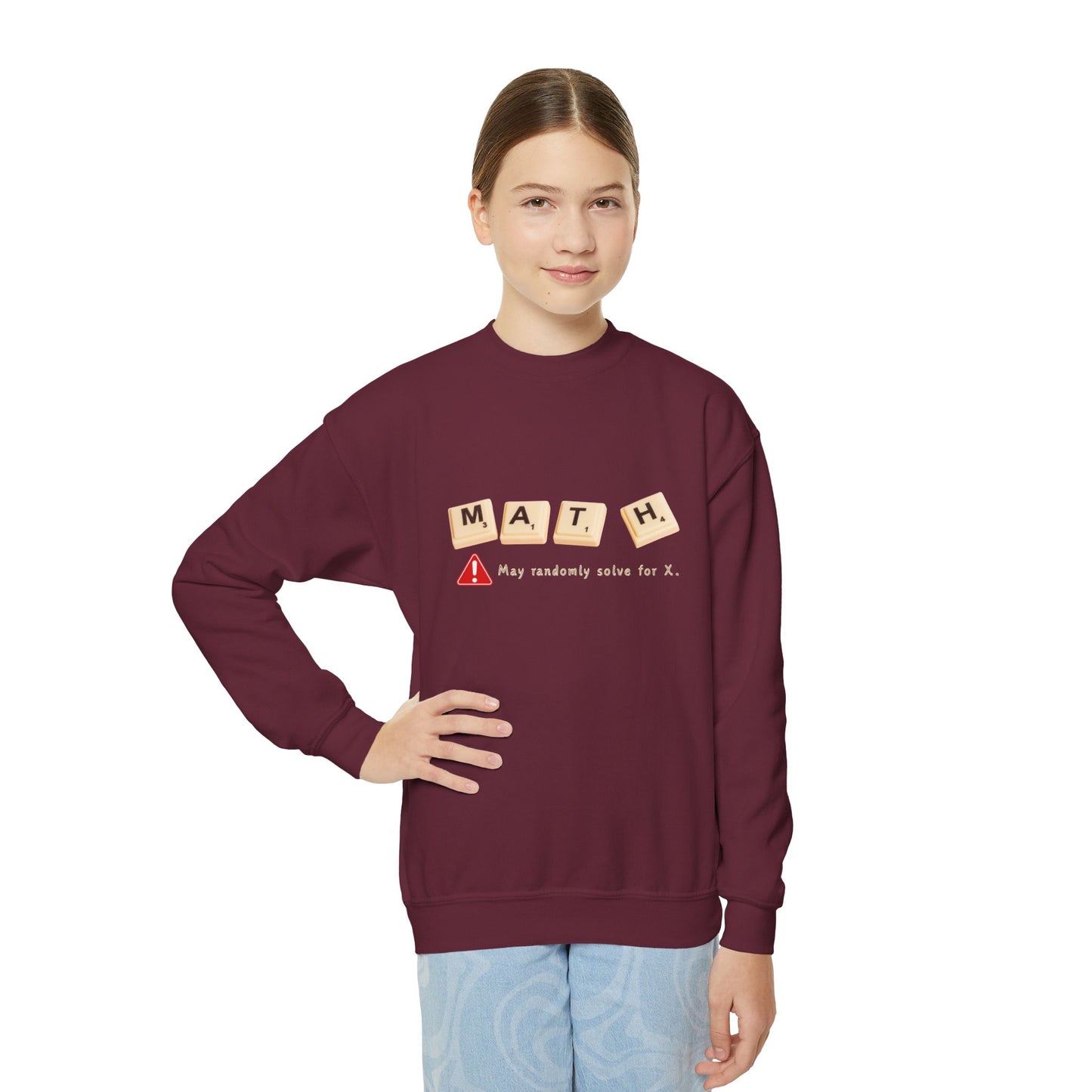 Girl wearing a maroon sweatshirt with 'MATH' game tiles and text 'May randomly solve for x'
