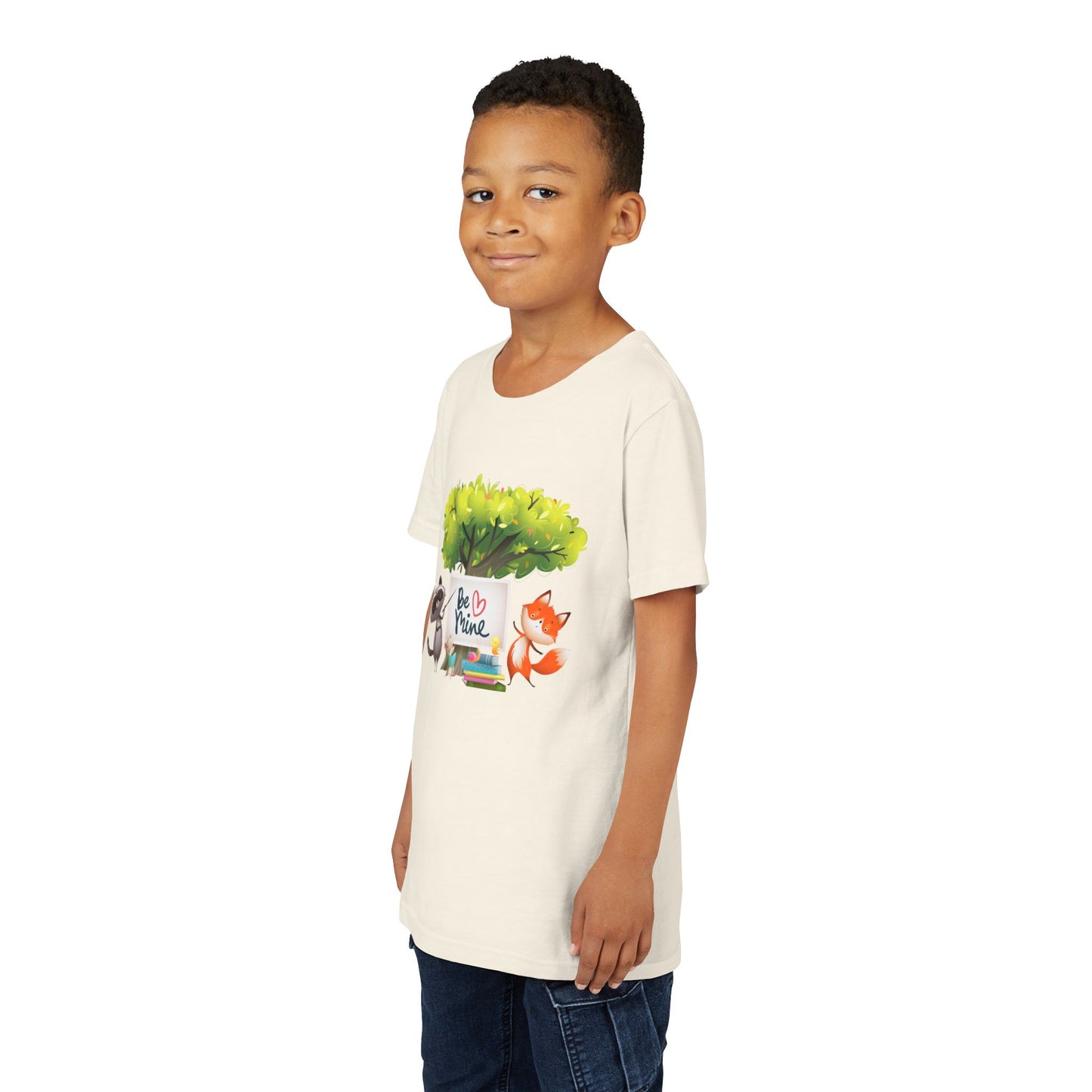 Boy wearing a beige t-shirt with a raccoon and fox graphic and 'Be Mine' text 