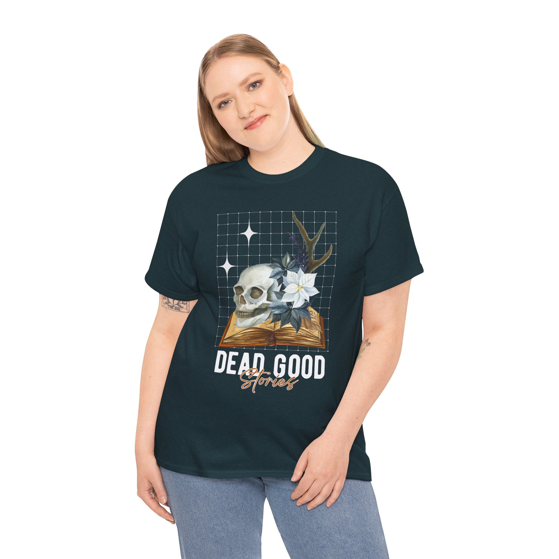 Woman wearing a midnight t-shirt with skull, antler, and flower on a book with text 'Dead Good Stories' on a hanger against a white background