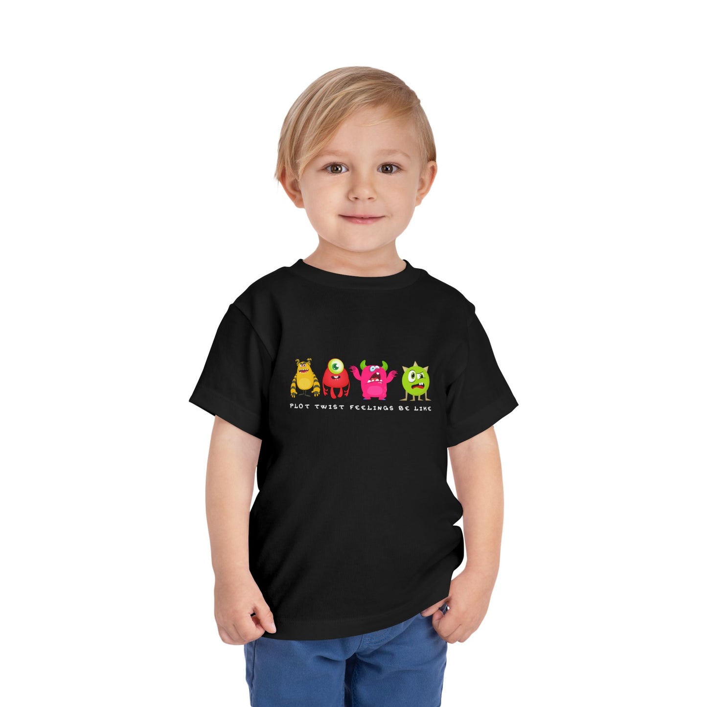 Child wearing a black toddler t-shirt with colorful cartoon monsters in a row with grumpy, confused and bewildered faces, text 'plot twist feelings be like'