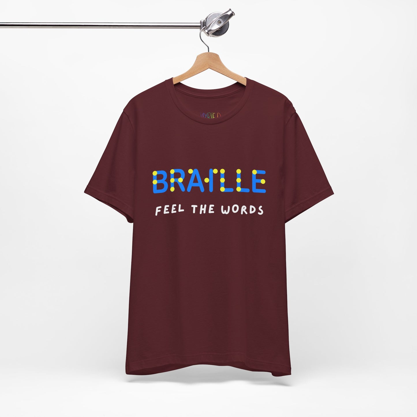 Maroon t-shirt with blue, yellow and white text 'Braille Feel the Words' 