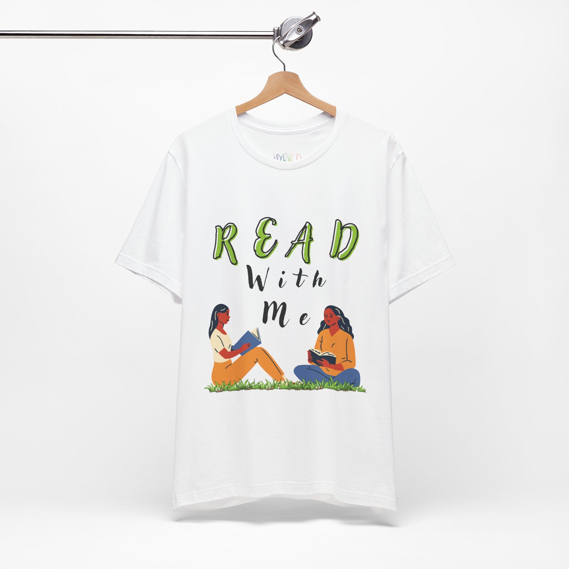 White t-shirt with 'Read With Me' text and illustrations of two people reading 