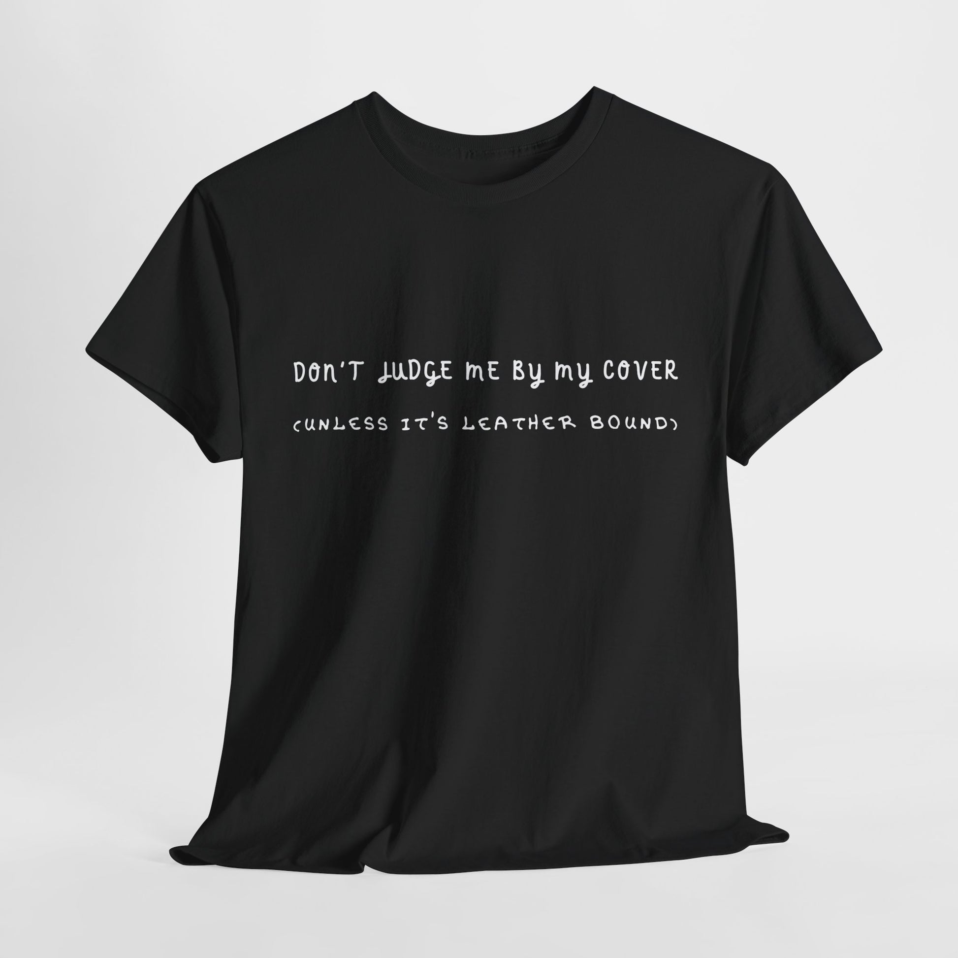 Black t-shirt with white text 'Don't Judge Me By My Cover - (Unless It's Leather Bound'