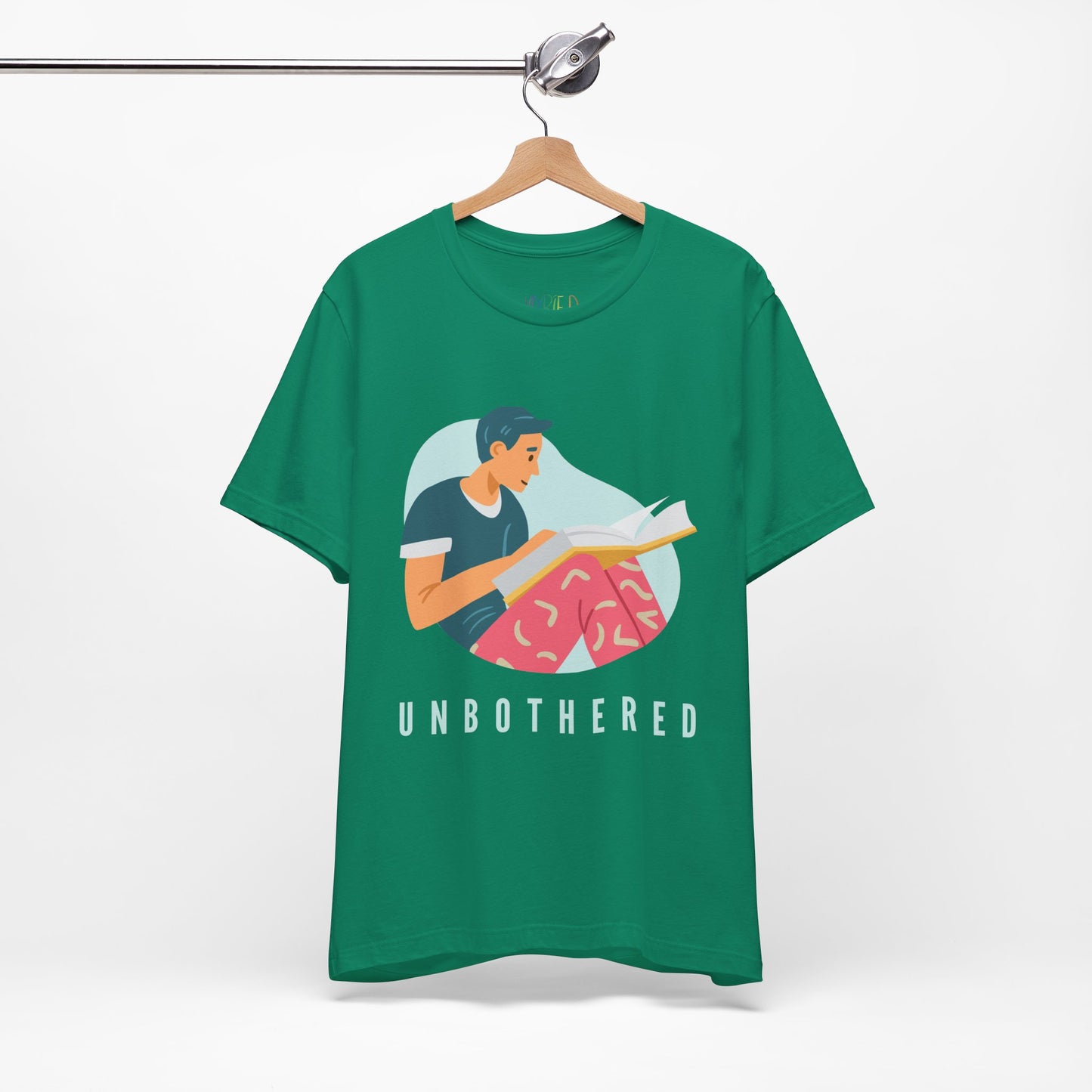 Green t-shirt with a man reading a book and 'UNBOTHERED' text 