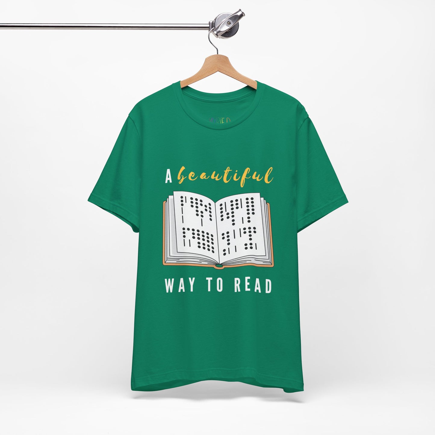 Green t-shirt with graphic design of a book in braille and text 'A Beautiful Way to Read'