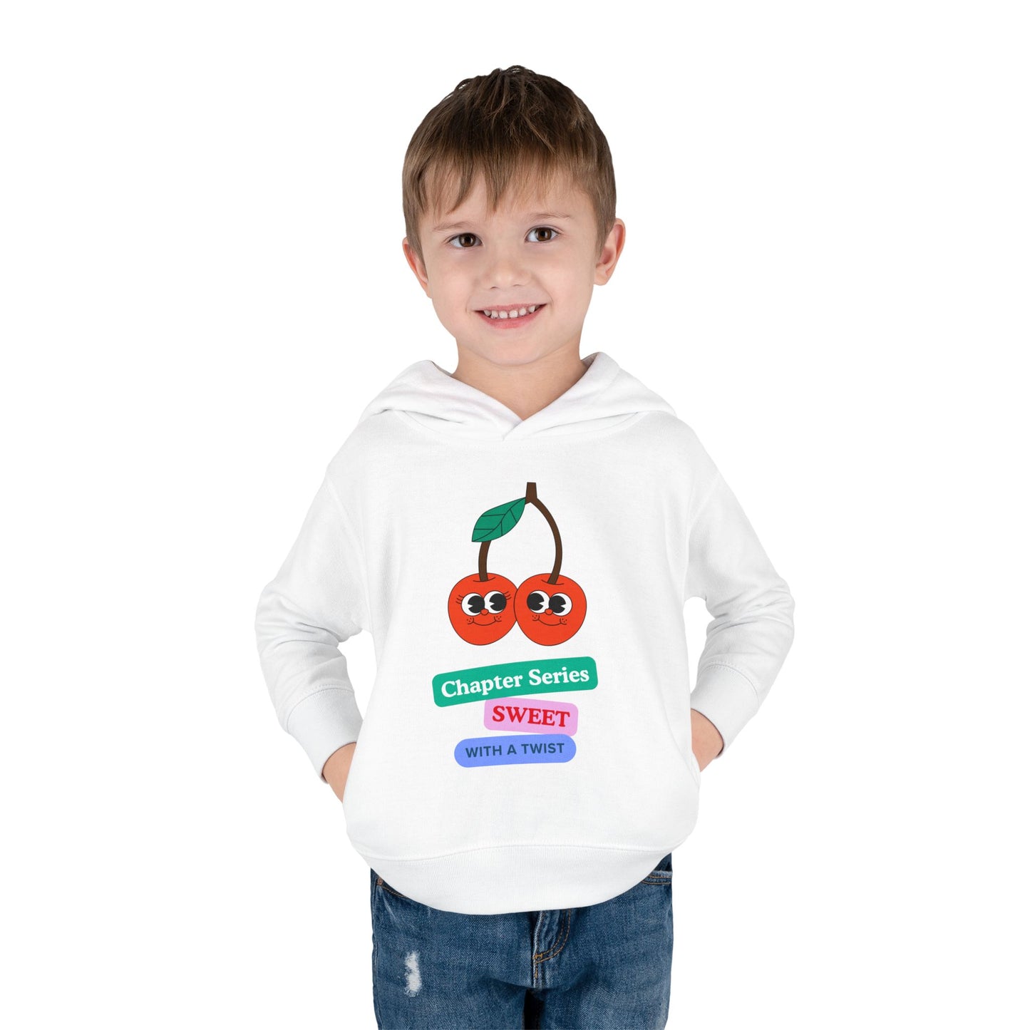 Boy wearing a white hoodie with to smiling cherries and colorful block text 'Chapter Series Sweet With A Twist'