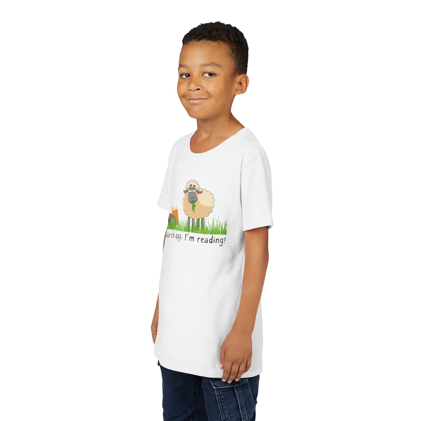 Boy wearing a white t-shirt with a sheep graphic reading a book and text 'Baaa-ck off, I'm reading!'