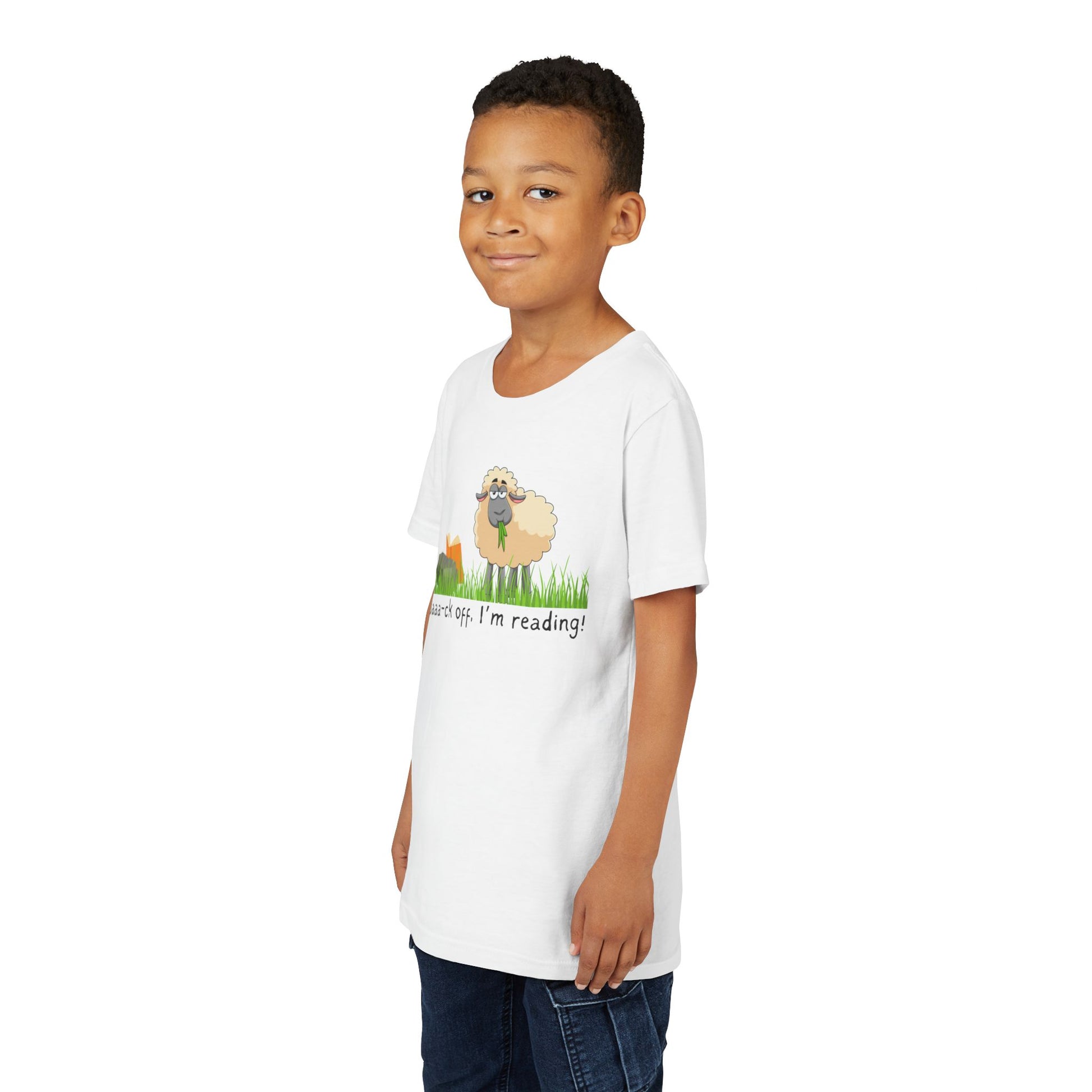 Boy wearing a white t-shirt with a sheep graphic reading a book and text 'Baaa-ck off, I'm reading!'