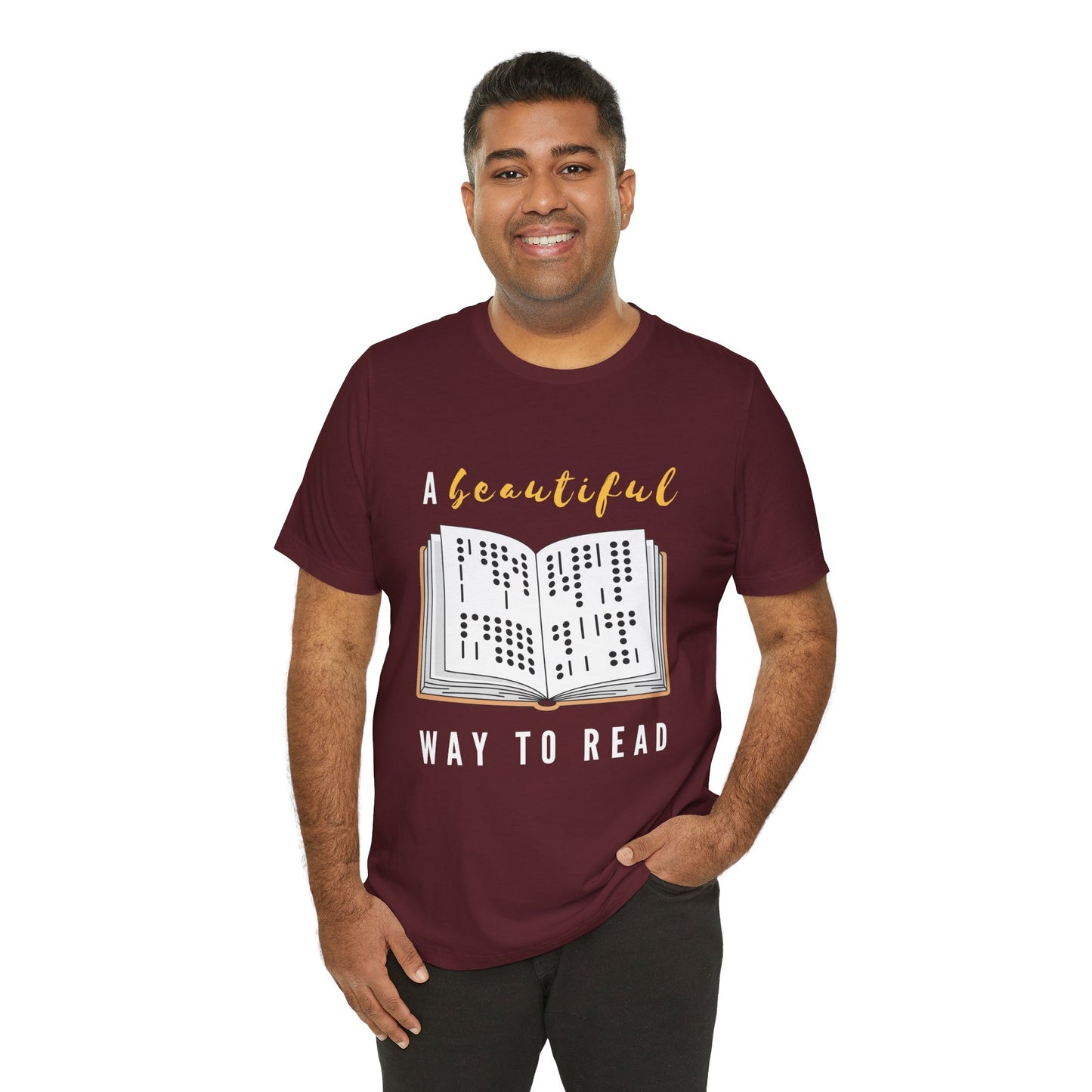 Man wearing a maroon t-shirt with graphic design of a book in braille and text 'A Beautiful Way to Read'