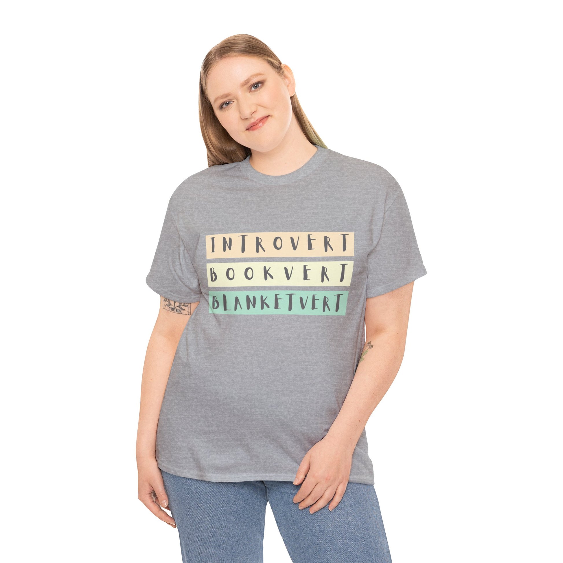 Woman wearing a gray t-shirt with soft colorful text 'Introvert. Bookvert. Blanketvert.'