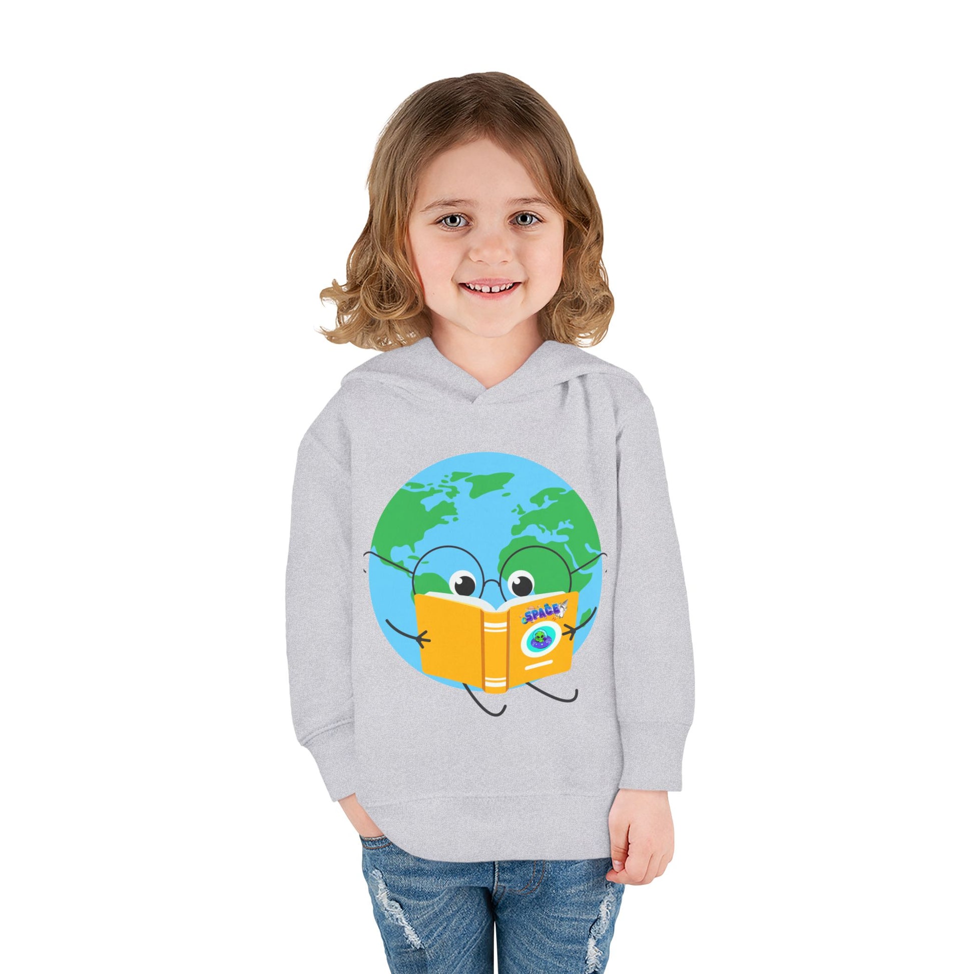 Girl wearing a light gray toddler hoodie with a cartoon Earth reading a space book