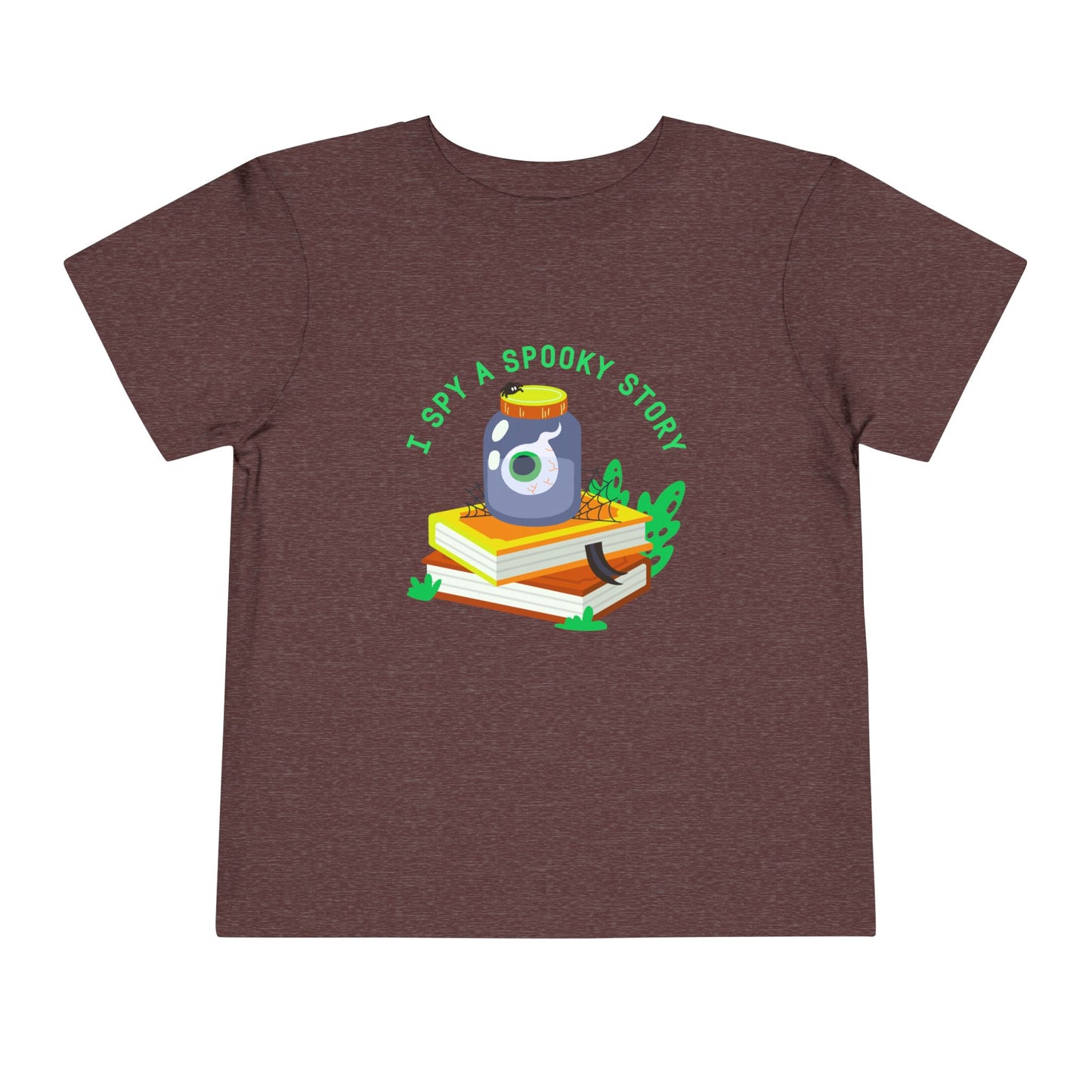 Maroon toddler t-shirt with an eyeball in a yar on top of books and text 'I spy a spooky story' on a white background