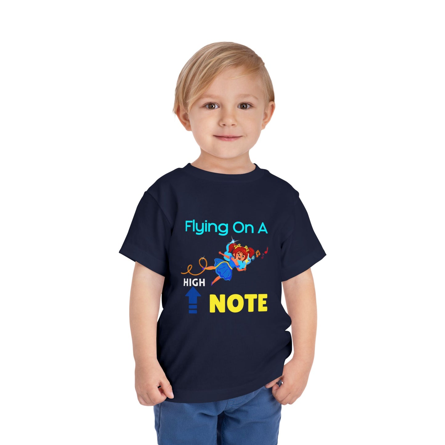 Child wearing a navy blue toddler t-shirt with a flying fairy graphic and playful text 'flying on a high note'