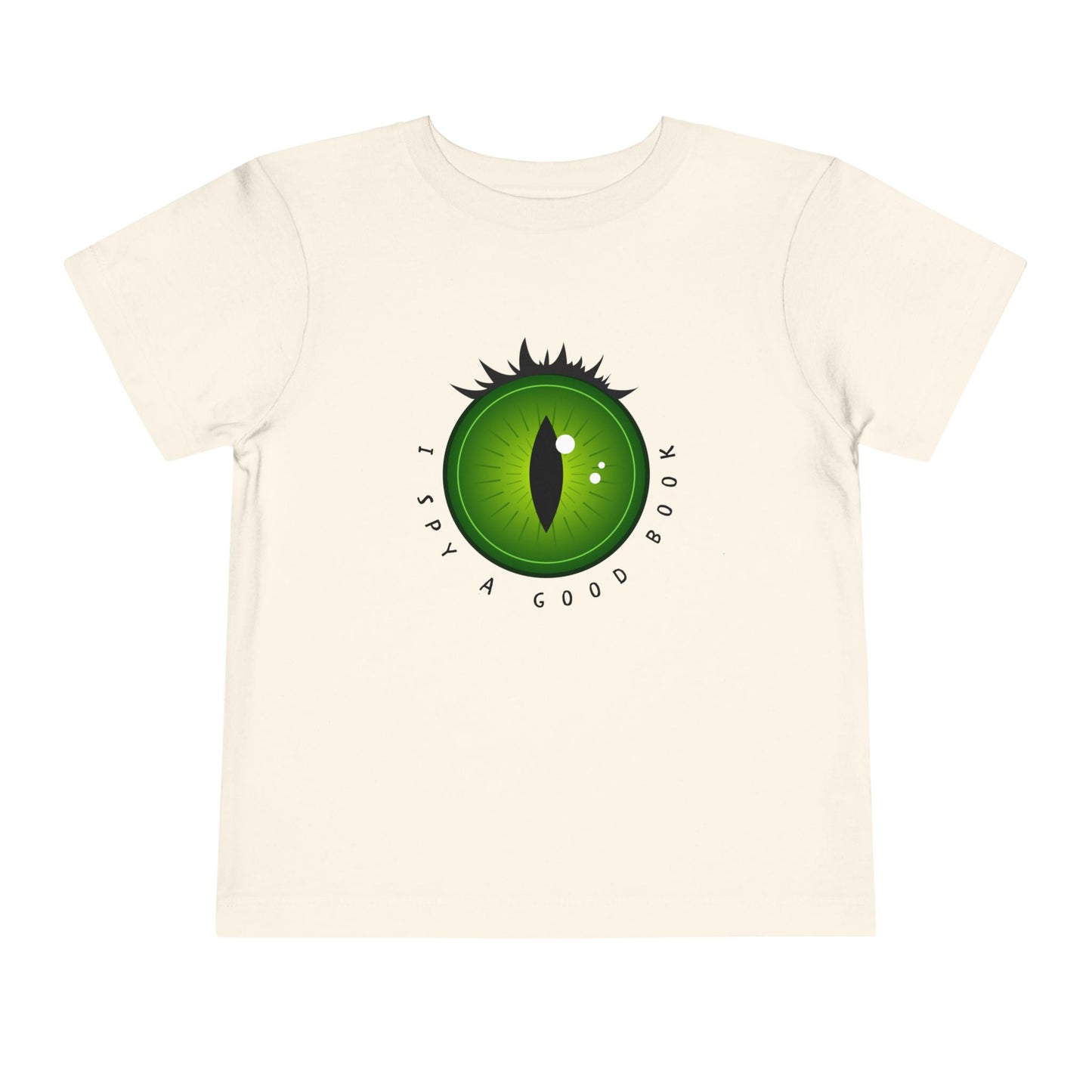 Beige t-shirt with a green dragon eye design and text 'I SPY A GOOD BOOK'