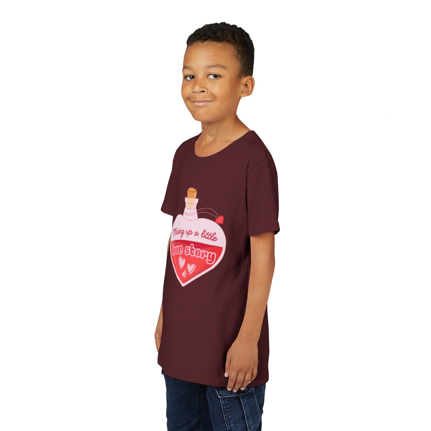 Boy wearing a maroon t-shirt with a heart-shaped potion bottle and text 'Mixing Up A Little Love Story' 