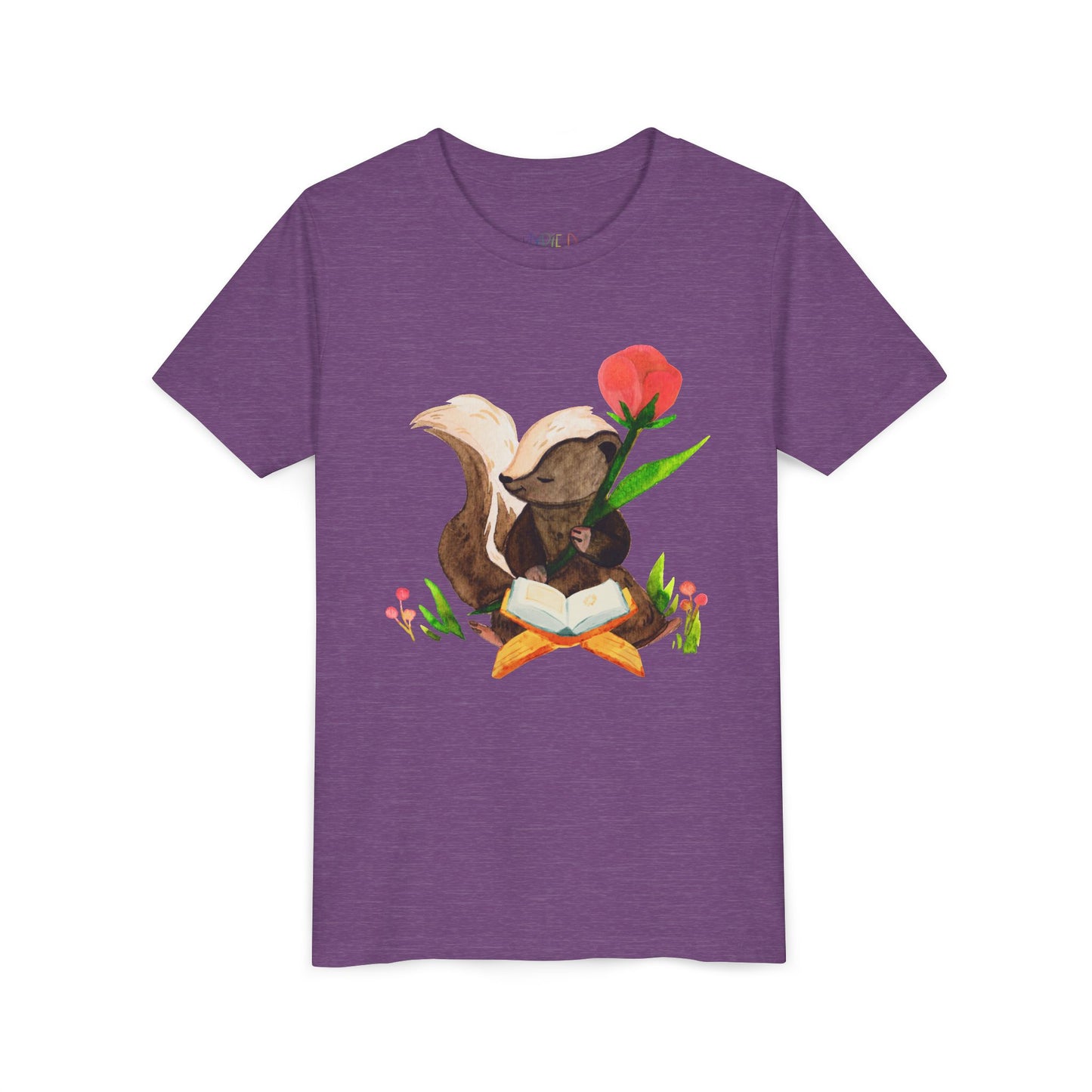 Purple t-shirt with a graphic of a skunk reading a book in a patch of flowers