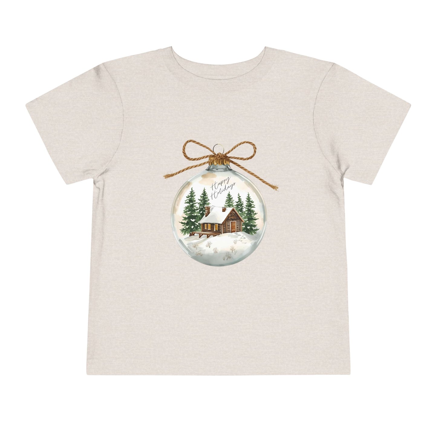 Beige/tan toddler t-shirt with a Christmas-themed ornament graphic featuring a cabin and trees 
