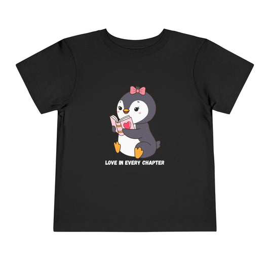 Black toddler t-shirt with a penguin reading a book and text 'Love in every chapter' 