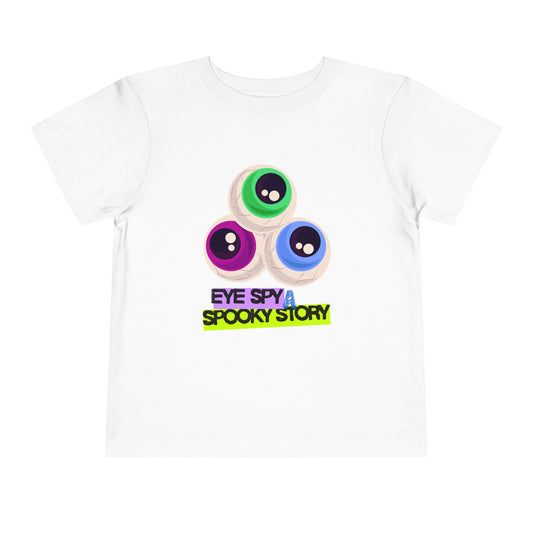 White toddler t-shirt with colorful eyeballs and text "Eye Spy A Spooky Story' on a white background