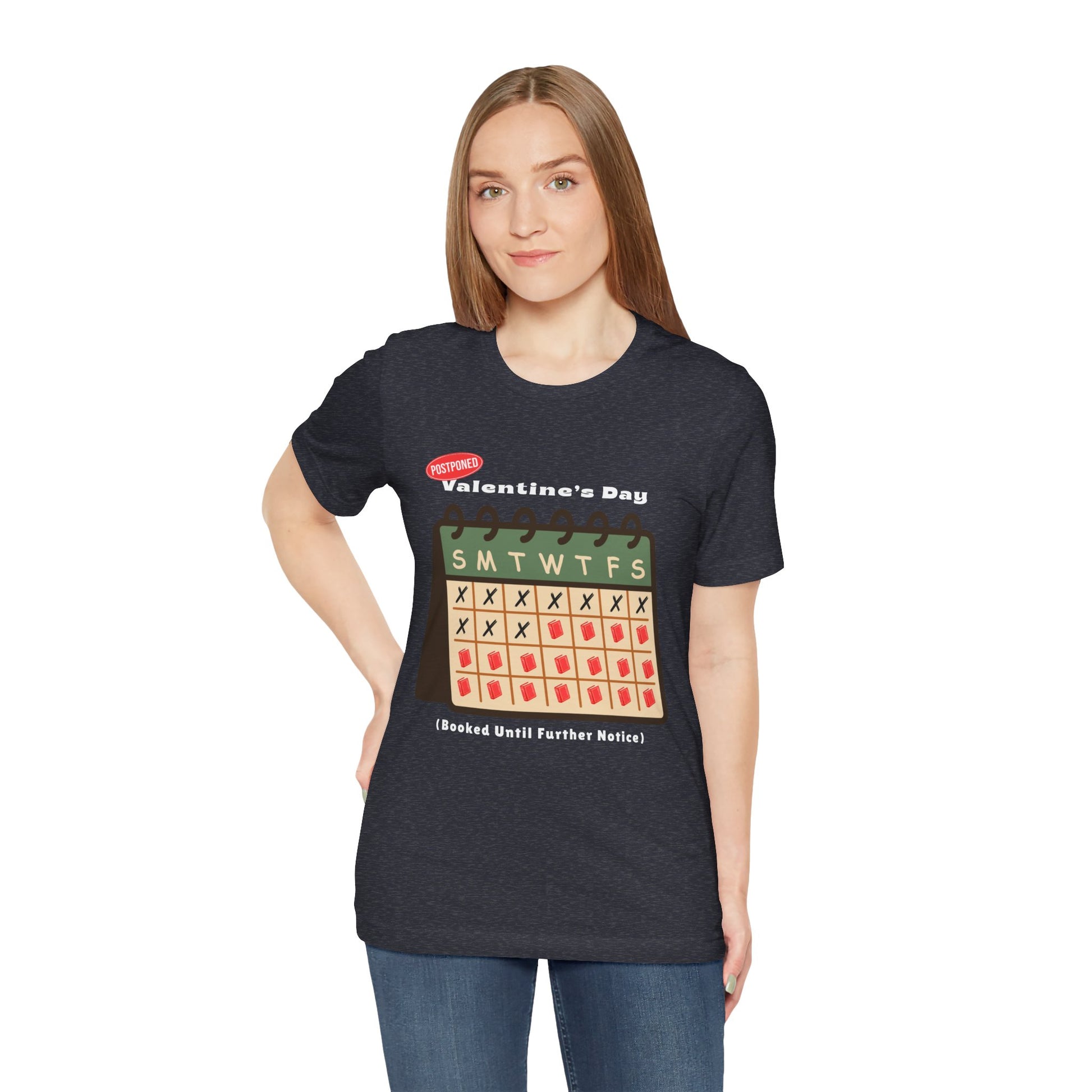 Woman wearing a heather navy t-shirt with a calendar and text 'Postponed. Valentine's Day (Booked Until Further Notice)' 