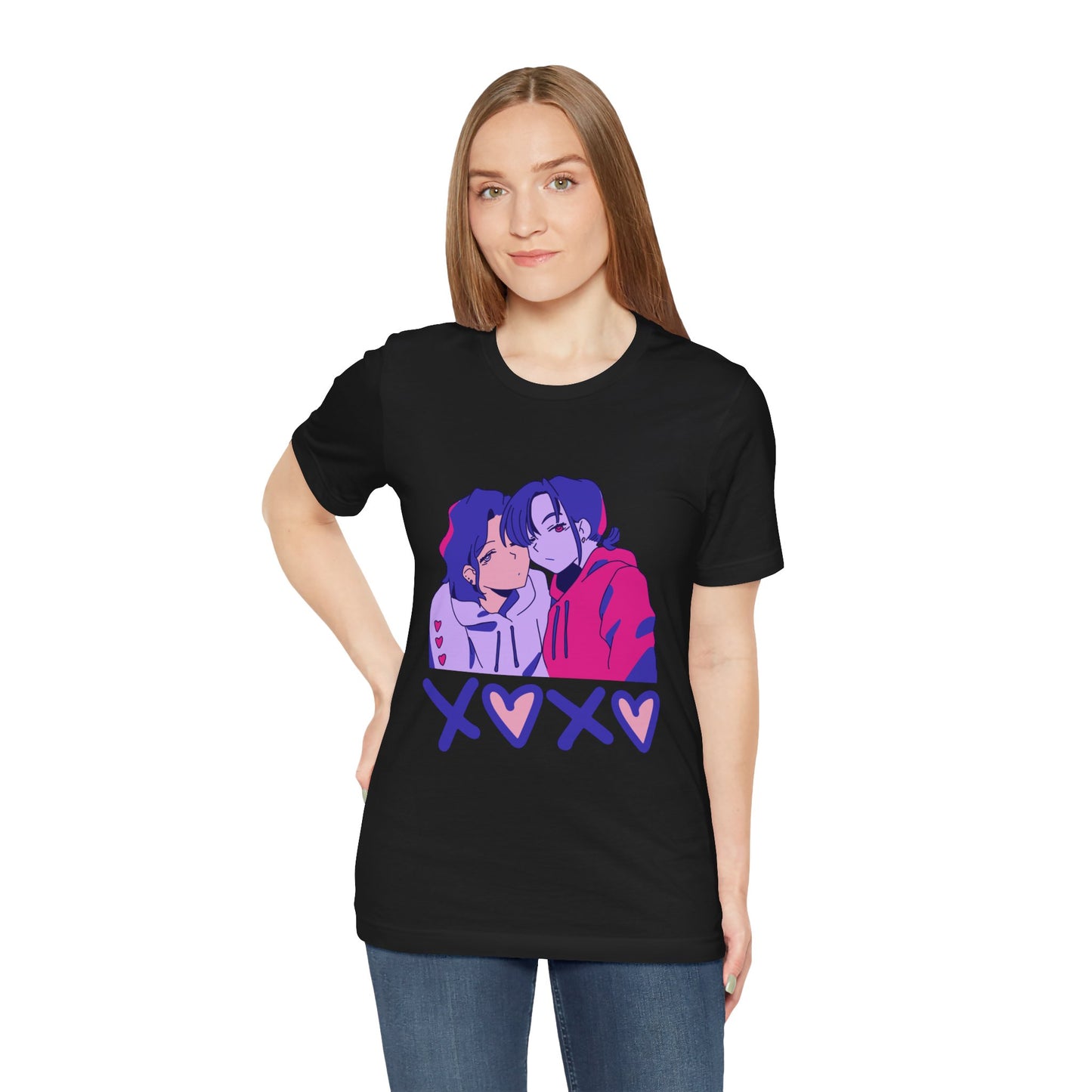 Woman wearing a black t-shirt with an anime pink, purple and blue graphic design of two people leaning in together above a row of XOXO (O's in the shape of hearts)