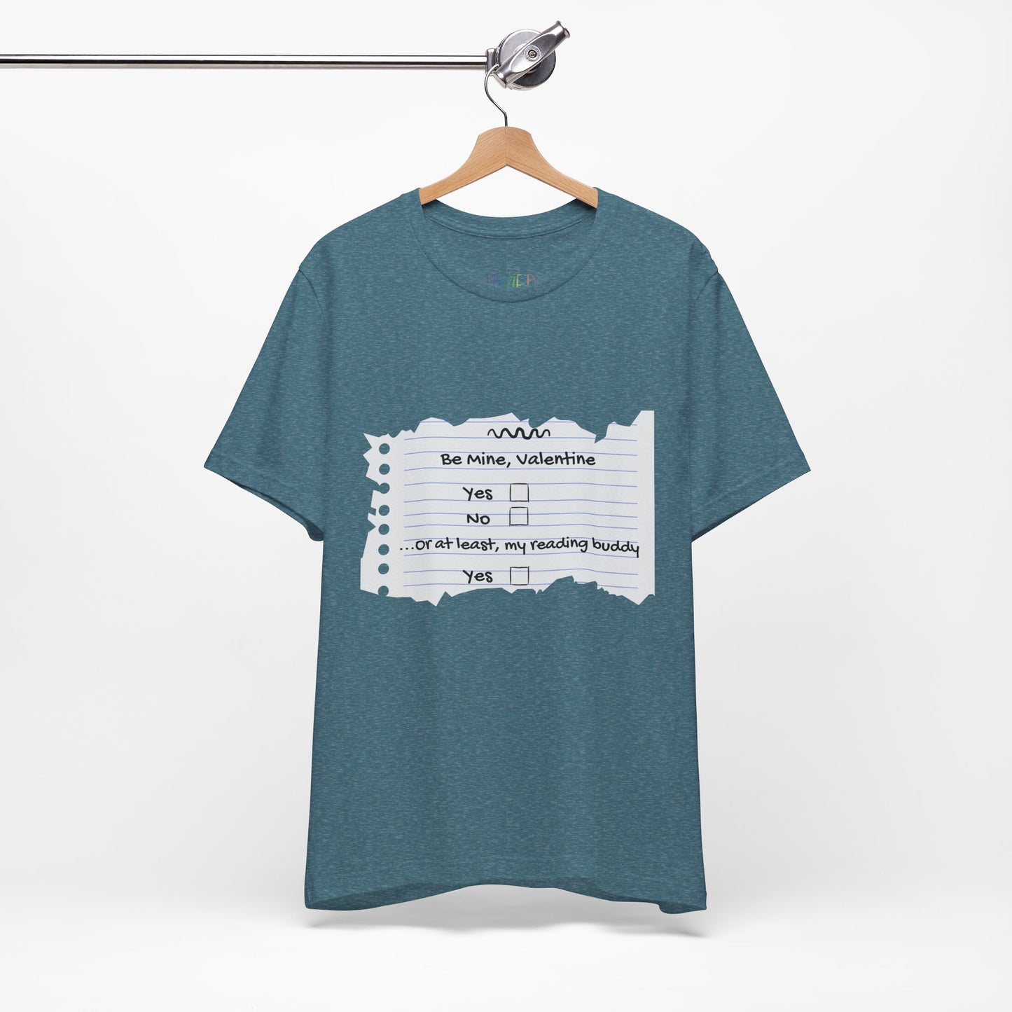 Blue t-shirt with an image of torn notebook paper and old school checkboxes depicting 'Be Mine Valentine, Yes, No' and 'Or At Least , My Reading Buddy, Yes'