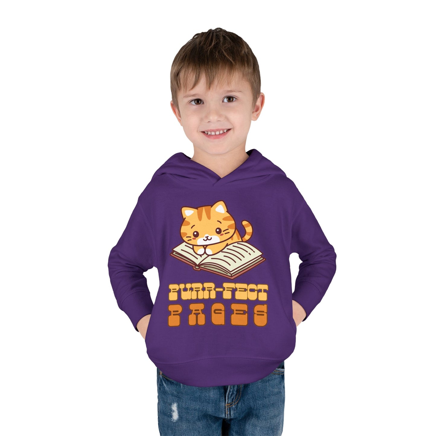 boy wearing a purple toddler hoodie with a cat graphic laying on a book and retro text 'Purr-fect Pages' 