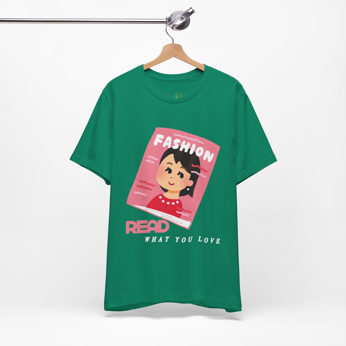Green t-shirt with a graphic design of a girl on a fashion magazine and text 'Read What You Love' 